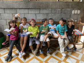 1st graders enjoying pizza they made themselves