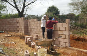 Sphe, one of our senior boys, helping the builder.