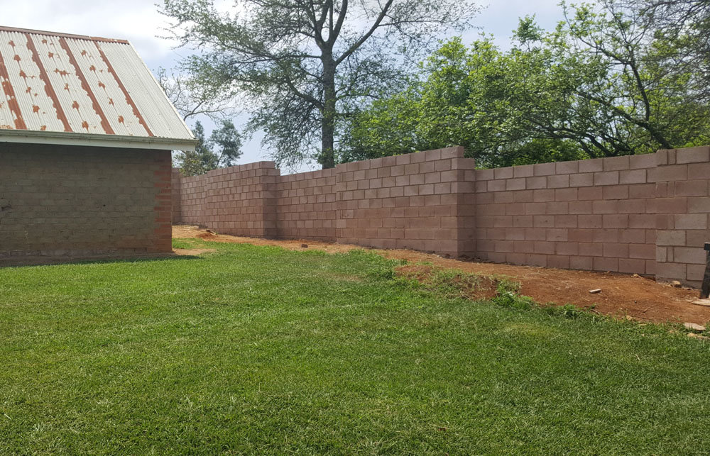 Completed section of wall behind a village house.