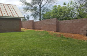 Completed section of wall behind a village house.