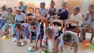 Pre-Schoolers eat nshima, chicken, & own veggies