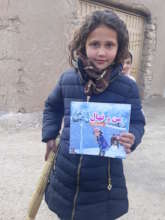 Happy young girl displaying the book she received