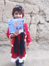 Happy young girl with the book, Kapisa province