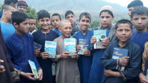 Children Displaying ABLE Books They Received
