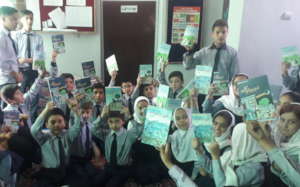 Children Displaying ABLE Books After Receiving