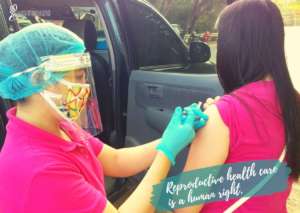Nurse Piety providing a young person her Depo shot