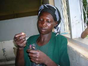 Careful work pulling the fringe of kitenge napkins