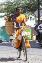 Baby while doing doorstep marketing on her bike