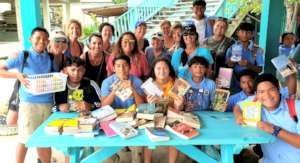 Visitors to OA bring books & school supplies