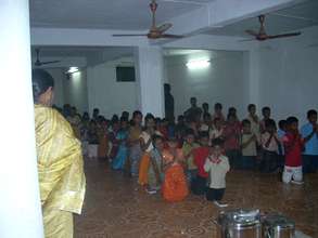 children praying in the dining hall