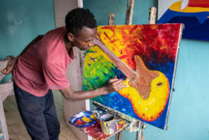 Uweza artist Kelvin working on a new piece