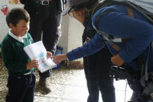Children showing bird drawings to an Ornithologist