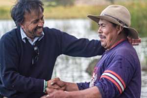 Felipe sharing with a local fisherman at Lake Tota