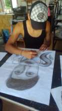 Student working in a self-portrait drawing