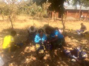 Girls being taught how to make re usable face mask