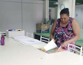 Atenizia selecting fabric in the ACER sewing room