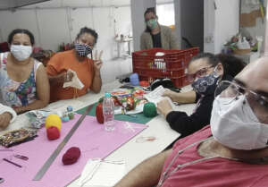 Fatima leads an embroidery class of new members