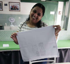 Viviane with a tea towel for embroidering