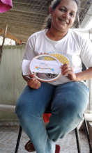 Adriana working on her embroidery at home