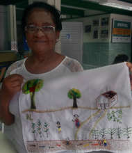 Valdete with her 'Childhood Memories' embroidery