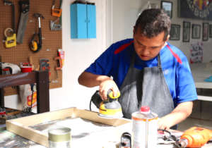 Gabriel very concentrated on smoothing a frame