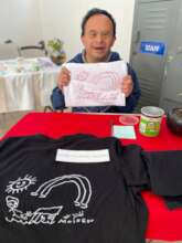 Moises selling T-shirts of his own design