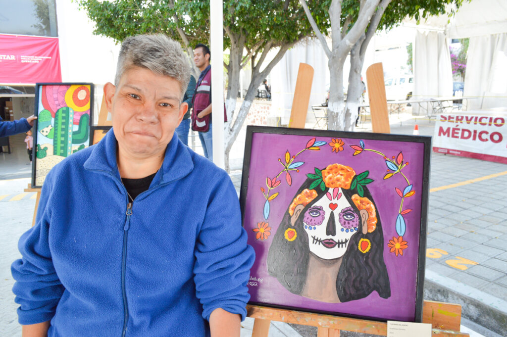 Lupita stands proudly in the latest painting expo