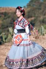 Xingqi wearing traditional Miao clothing