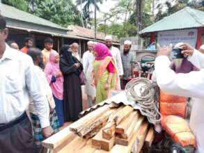 Distributing Sanitary latrine to the poor Families