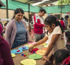A mother participating in the community fair