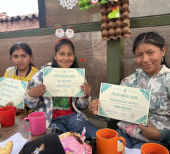 Girls showing their certificates of achievement.