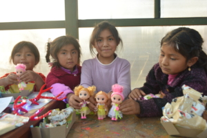 Girls showing their new dolls from Christmas.