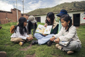 Teacher Mara sharing a story with the girls