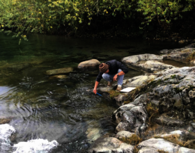 Marcelo Gonzalez measuring water temperature.