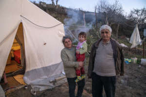 Naim and his family outside their tent
