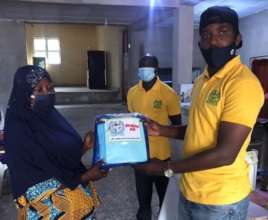 Team member presenting kit to a beneficiary.