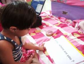 Shravi reads one of her homemade books.