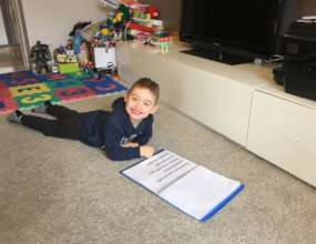 Daniel reads one of his homemade books