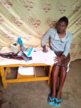 Olive uses her solar lamp and kindle to study.