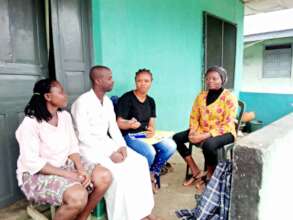 PCEF staff counselling parents during home visit