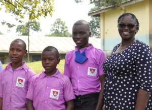 Students with primatologist Dr. Emily Otali