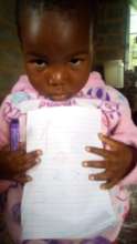 Tiny Tot Showing off her Learning at Home work