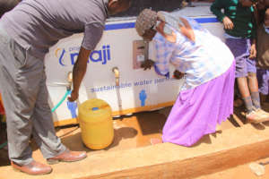 Community woman taps the e-payment token for water