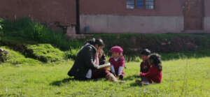 Young children reading with one of our teachers