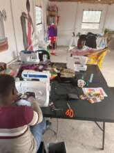 our Volunteers learning how to sew