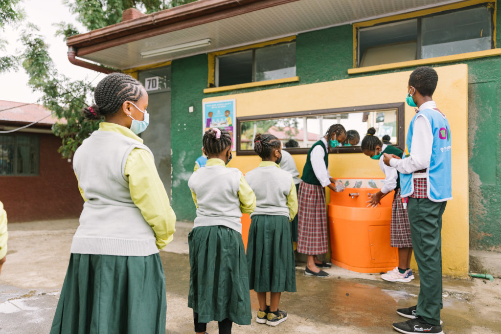 Hygiene club member oversees handwashing