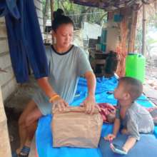 Mom and son receive food in makeshift shelter