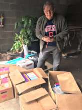 Director Santoli with donations at warehouse