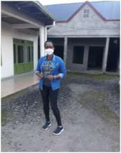 On my left is a hall,  behind me are single rooms.