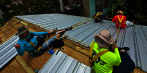 Apprentices installing the new galvalume roof.